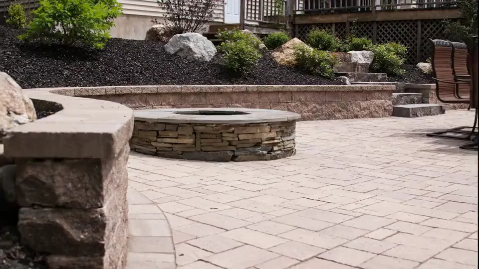 Raised planting beds with boulders and evergreens