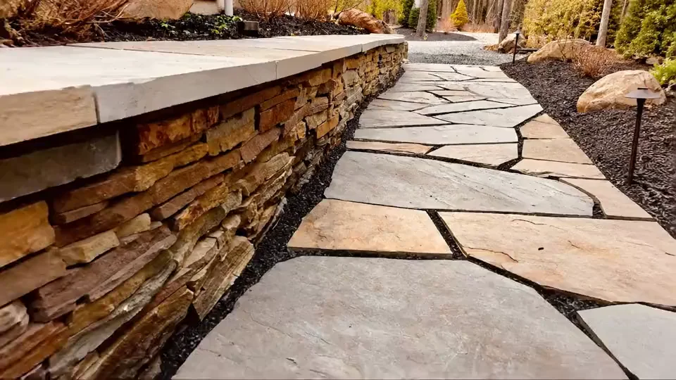 Dry-stacked natural stone wall and flagstone walkway